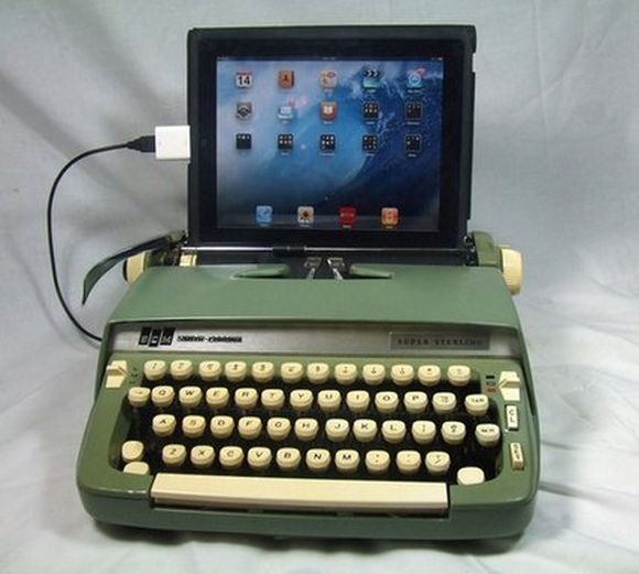 old school typewriter connected to tablet 