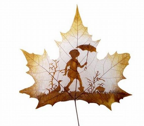 kid with umbrella carved on leaf