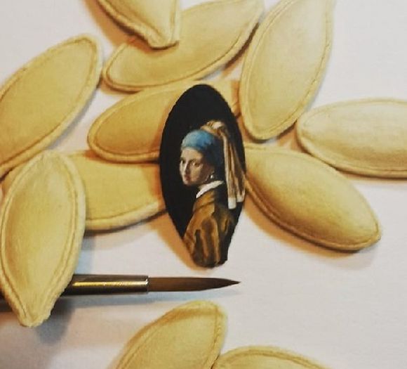 girl with a pearl earring micro art on a pumpkin seed 